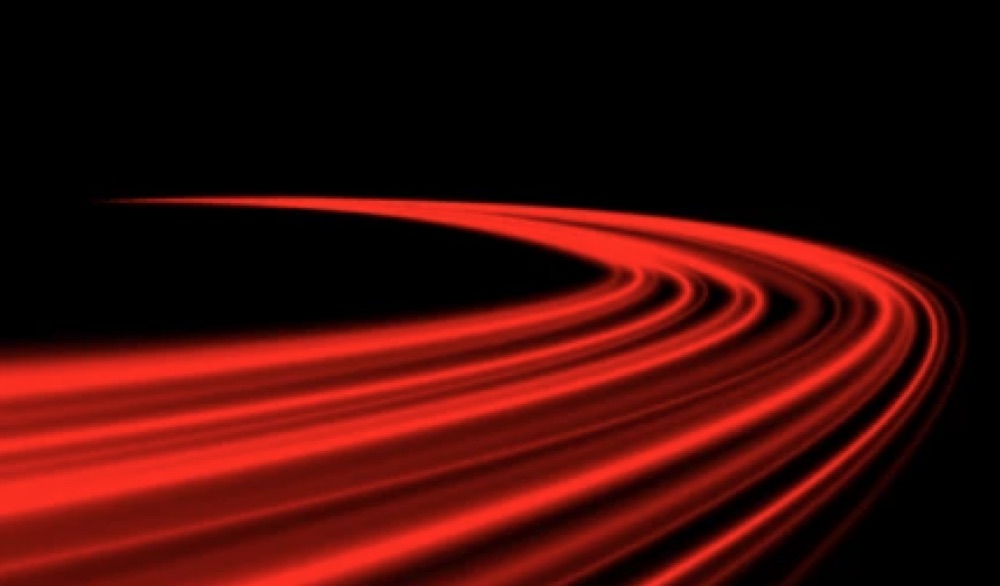 Reference still: red light trails sweeping across black